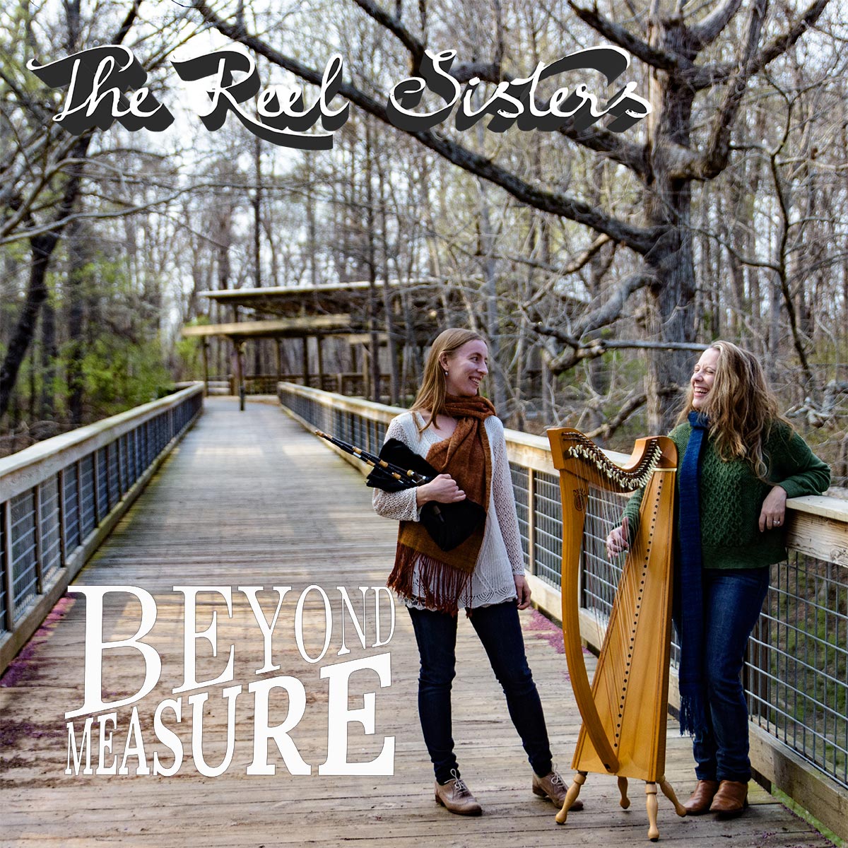 Beyond Measure CD cover. It says The Reel Sisters, Beyond Measure and has an image of Rosalind and Kelly on a bridge with their instruments.